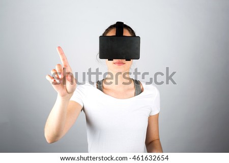 View of a Young attractive woman using a virtual reality headset for first time