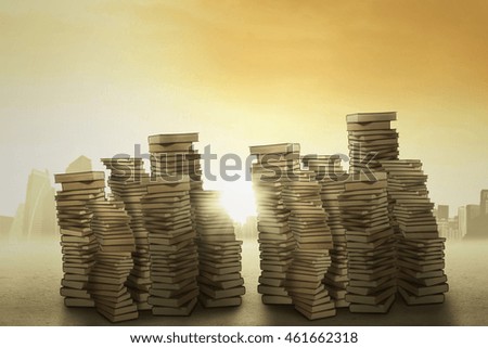 Picture of a pile of books, shot outdoors under clear sky with bright sunlight