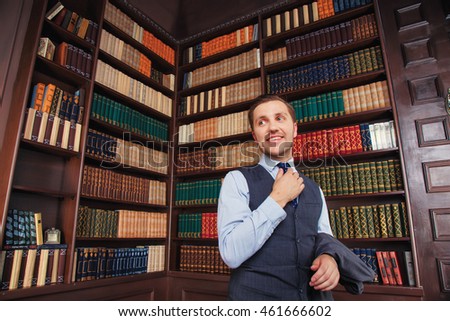 Business smart hipster lawyer man near bookcase