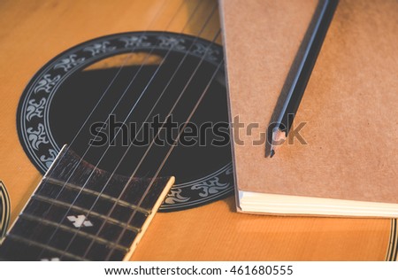 Guitar and notebook for writing music,Vintage retro picture style