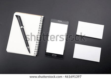 Business card blank, smartphone or tablet pc, flower and pen at office desk table top view. Corporate stationery branding mock-up