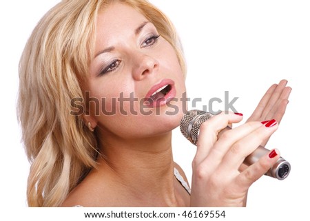Pretty girl singing into microphone.  Young female singer with blond hair singing a song. Woman laying down some vocal tracks. Leader of pop music band on white background.