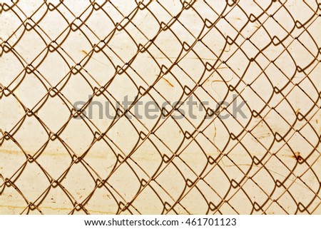 abstract chain link fence texture against grungy color wall. Background and texture for design