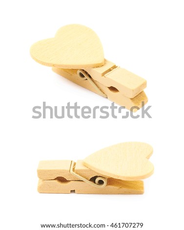 Tiny heart shaped colored wooden peg pin isolated over the white background, set of two different foreshortenings