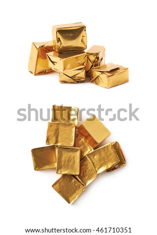 Pile of multiple bouillon stock broth cubes wrapped in golden foil, composition isolated over the white background, set of two different foreshortenings