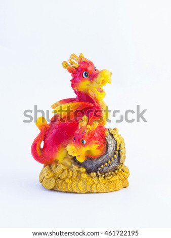 Figures of two red dragons sitting on a pile of gold coins