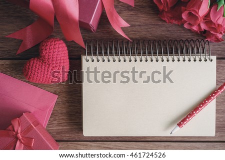 Blank open notebook with gift box and red heart shape, Valentines day background concept