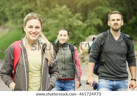 Walking family or friends. Hikers in forest at sunset.