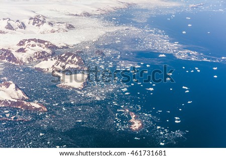 Greenland. Icebergs near the Eastern coast. This is a consequence of the phenomenon of global warming and catastrophic thawing of ice. The view from the plane
