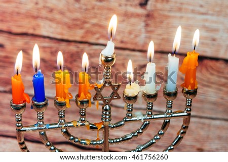 Image of jewish holiday Hanukkah background with menorah traditional candelabra Burning candles