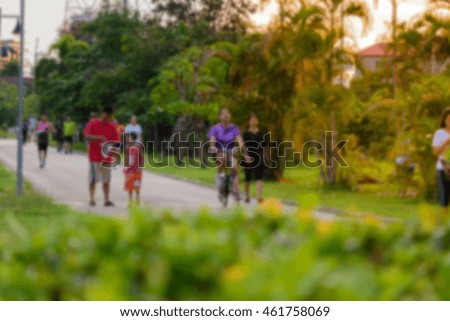 People walking or jogging in public park during evening for healthy and good life.Blurred image for background, maybe.