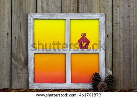Rustic window with blank colorful window panes by pine cones with antique aged wood background