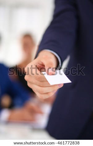 Closeup of a business man standing with card