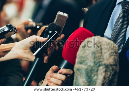 Interviewing business man on press conference Royalty-Free Stock Photo #461773729