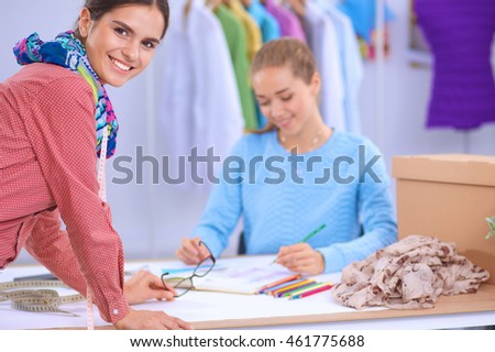 Modern young fashion designers working at studio.