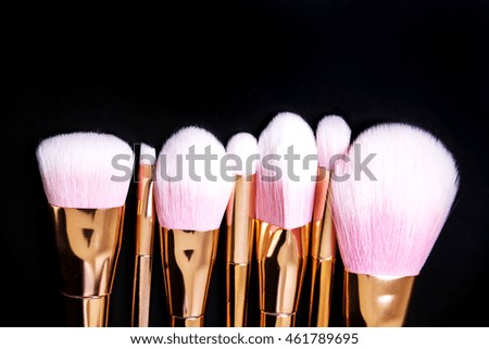 Professional makeup brushes collection on black background