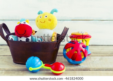 Baby toys, toddler toys or infant toys including stuffed animals and rattles in a gift basket