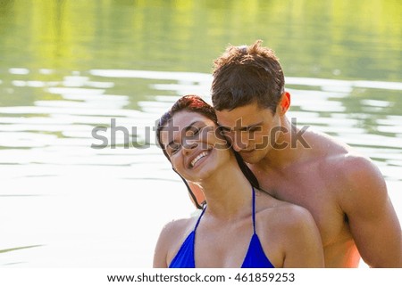 Young couple cheek to cheek in river