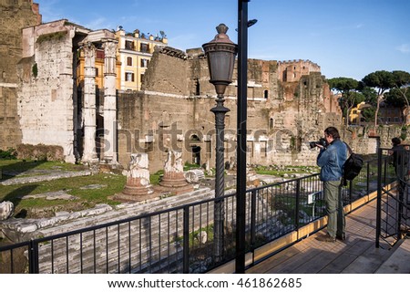 Tourist takes a picture in the Forum of Augustus in Rome, Italy.