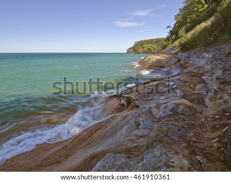 The Lake Superior Shore near Miner's Beach is colorful sandstone rock climbing out of the azure waters of Lake Superior, Picture Rocks National Lakeshore, Alger County, Michigan