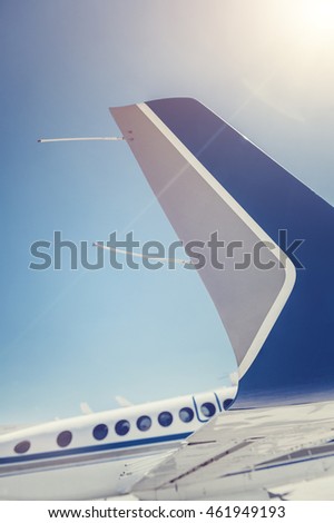 Plane in the air, wing of a great aeroplane over blue sky background, business trip, travel and vacation concept