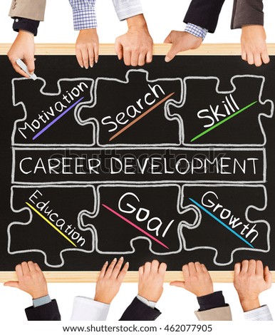 Photo of business hands holding blackboard and writing CAREER DEVELOPMENT concept