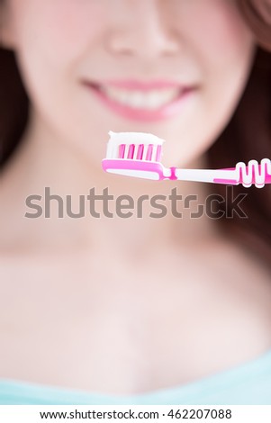 Beautiful young woman with health teeth and charming smile.holding the tooth brush, asian beauty