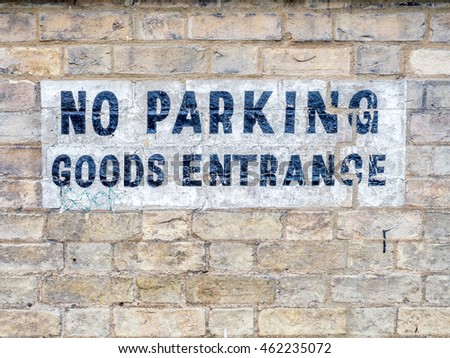 No Parking sign on brick block building