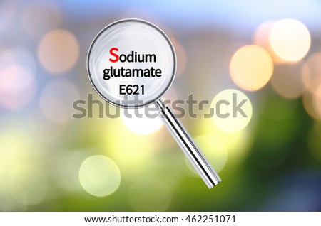 Magnifying lens over background with text Sodium glutamate, with the blurred lights visible in the background. 3D rendering.