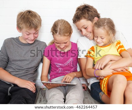 Children with tablet. Group kids playing 