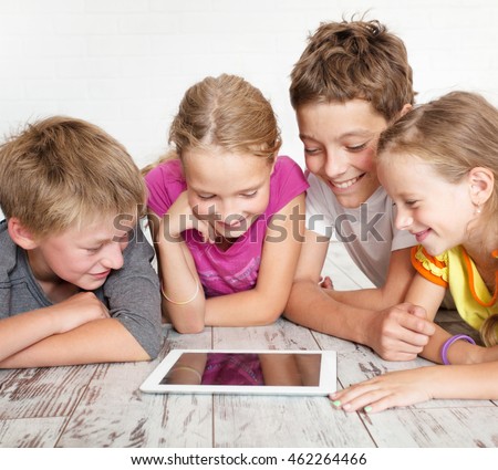 Group children with tablet. Happy girls and boys