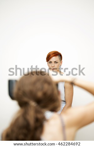 Girl posing in front of the female photographers