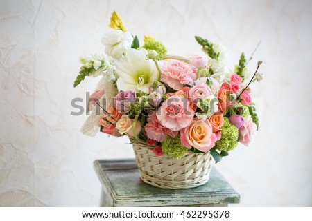 Many beautiful flowers in basket. Rose, peony, carnation and other