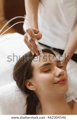 Face Beauty Treatment. Closeup Of Beautiful Woman Getting Facial Gas-liquid Oxygen Water Epidermal Peeling Using Professional Equipment At Cosmetology Center. Skin Care Concept. High Resolution Image