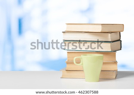 Pile of books with cup