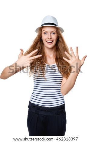 Hand counting - eight fingers. Happy excited summer woman in straw fedora hat showing eight fingers