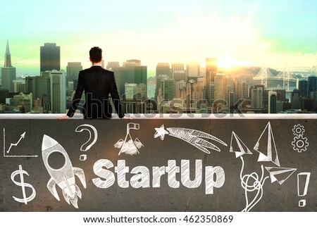 Startup concept with sitting businessman looking at city and rocket ship sketch on concrete wall