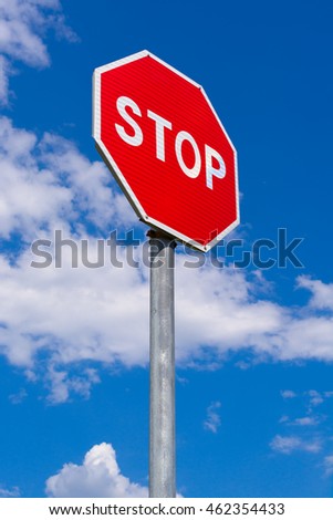 Road stop sign on a background of clouds