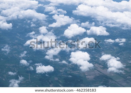 Clouds and land, aerial view from airplane window