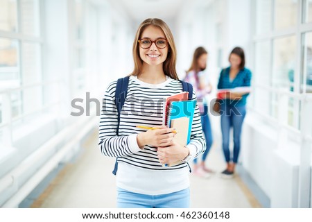 Portrait of female college student smiling at camera Royalty-Free Stock Photo #462360148