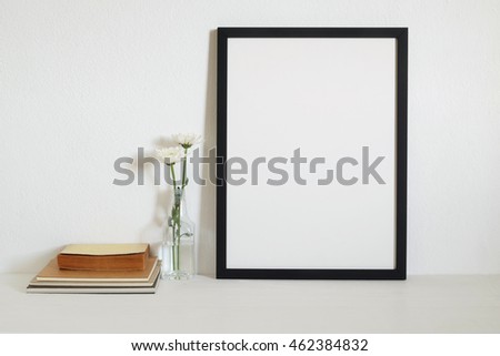 mock up  frame with book and flowers on  table.modern home decor