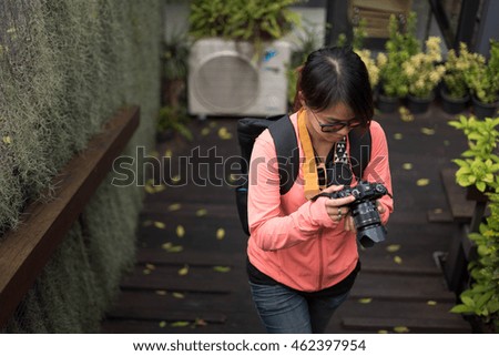 women in photographer look taking a photo with natural view