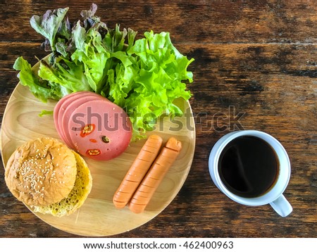 Breakfast with bread, cheese sausage ,baloney sausage and coffee
