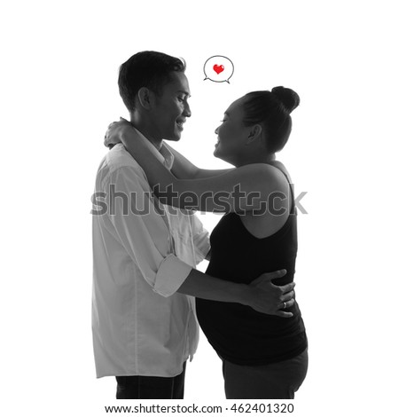 Pregnant woman and her husband embracing and expressing their love for each other. Conceptual monochrome portrait, isolated on white