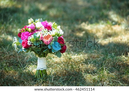 Wedding bouquet of roses on green grass