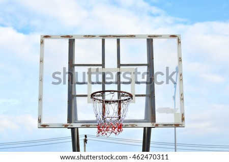 old basketball hoop with sky and cloud
