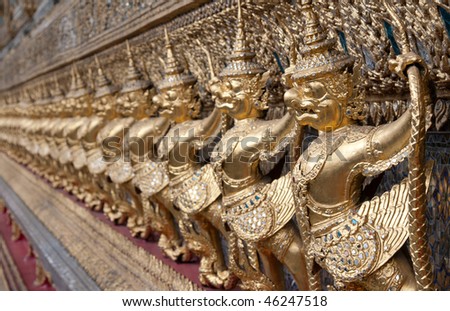 Golden figures warrior in royal palace stand in row