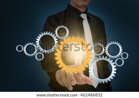 Business man touch gear elements on screen