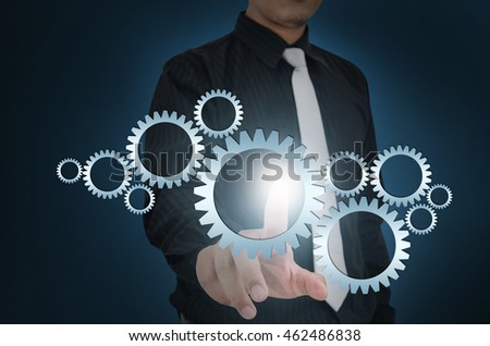 Business man touch gear elements on screen