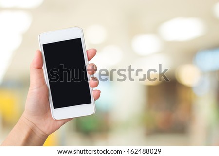 Smart phone with  black screen in hand on blurred in airport background